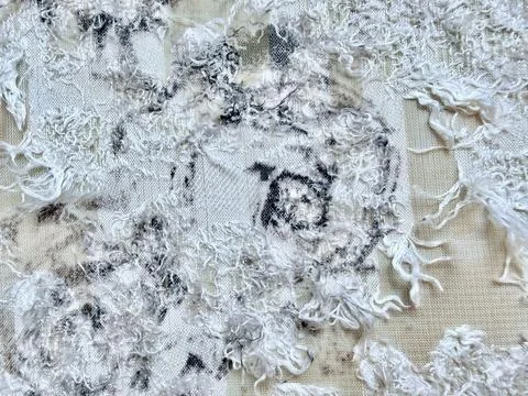 Distressed white textile texture showcases frayed threads and abstract tie dy Stock-Fotos