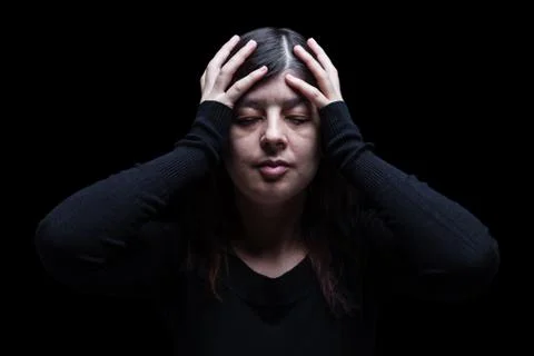 Distressed, woman holding the head with the hands Stock Photos
