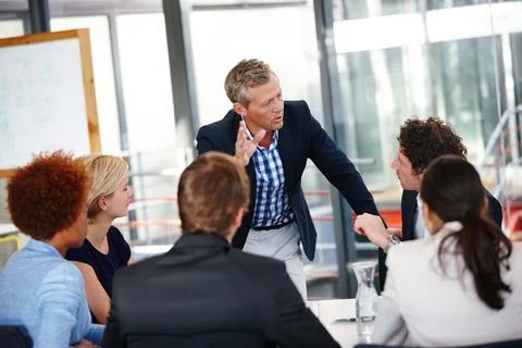 Distributing tasks to the team. Cropped shot of a group of business Fotos Stock