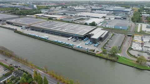 Distribution center parking Albert Heijn with trucks parked near river Stock Footage 320173668