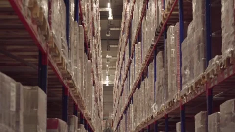 Distribution Center. Rows of shelves inside an industrial warehouse with boxes. Stock Footage 249501177