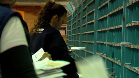 Distribution Center Workers Managing Postal Mail and Envelopes - Close Up  Stock Footage 154876959
