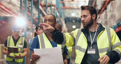 Distribution, documents and people in warehouse, discussion or logistics with Stock Footage 323999198