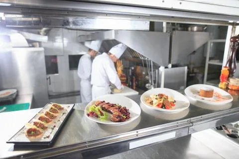 The distribution table in the kitchen of the restaurant. the chef prepares a Stock-Fotos