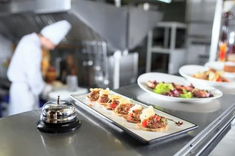 The distribution table in the kitchen of the restaurant. the chef prepares a Stock Photos