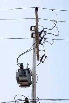 Distribution transformert on the concrete pole and wires. Stock Photos