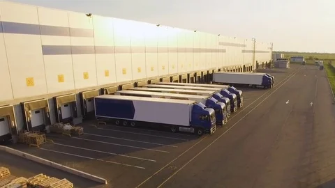 Distribution warehouse with trucks awaiting loading Stock Footage 78113811