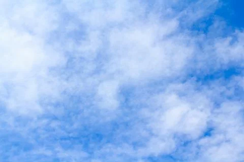 Distribution of white clouds on the clear blue sky for background texture Stock Photos