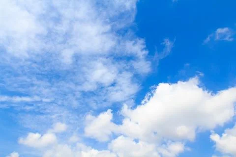 Distribution of white clouds on the clear blue sky for background texture Stock Photos