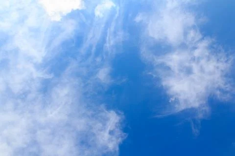 Distribution of white clouds on the clear blue sky for background texture Stock Photos