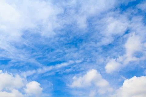 Distribution of white clouds on the clear blue sky for background texture Stock Photos