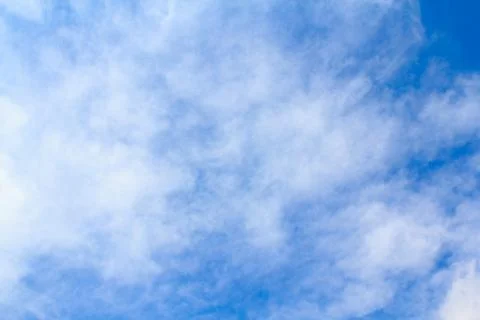 Distribution of white clouds on the clear blue sky for background texture Stock Photos
