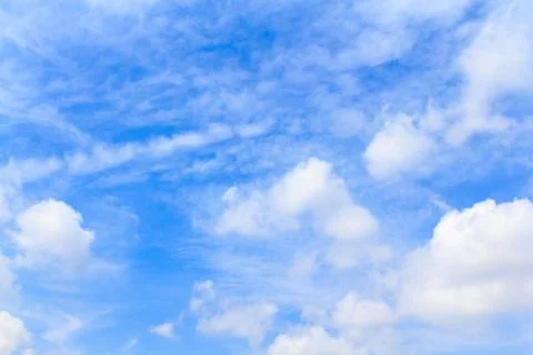 Distribution of white clouds on the clear blue sky for background texture Stock Photos