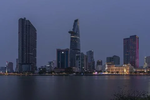 District 1 of Ho Chi Minh City at night seen from across the Saigon River w.. Stock Photos