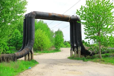 District heating pipe passing over a displaced dirt road Foto stock