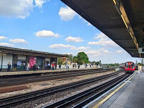 A District Line train approaching the platform at Chiswick Park Station Stock Photos