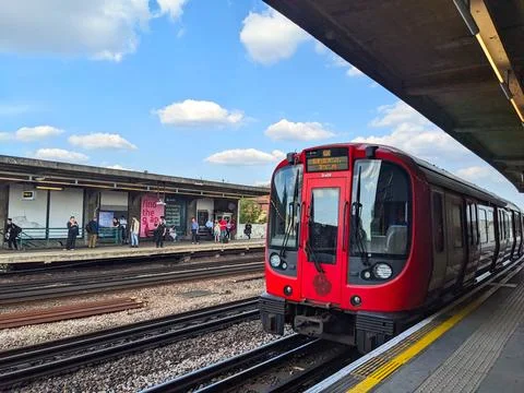 A District Line train approaching the platform at Chiswick Park Station Stock Photos