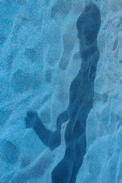 Disturbing shadow in sandpit Stock Photos