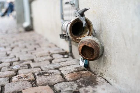 Disused pipe coupling formerly used to receive beer from tank truck. Stock Photos