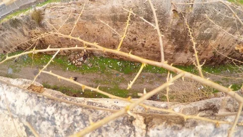 Ditch of Urfa Castle Through Spiny Branches Snow and Rain Stock Footage 75410552