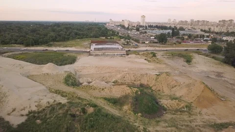 Ditch with water at the construction site with heaps of sand and earth. Aerial Video stock 109408518