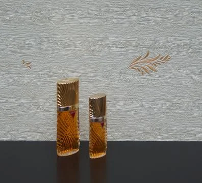 Diva, big perfume bottle in front of the satin wallcovering Elysee Stock Photos