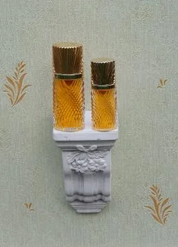 Diva, large perfume bottle next to a commercial perfume bottle on a wall console Stock Photos