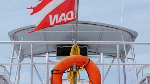 Dive boat at dock with Diver Alert Network and life ring Stock Footage 87372696