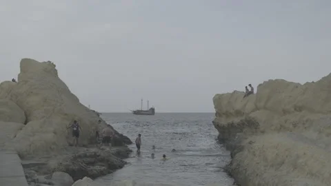 A dive from the Monastir cliffs on Qaraiya Beach in Monastir in Tunisia Stock Footage 244804994