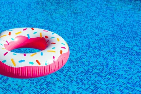 Dive into poolside delight with doughnut float. Concept of leisure time Stock Photos