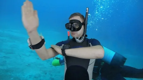 Divemaster shows direction on the compas- greenscreen footage Stock Footage 123951552