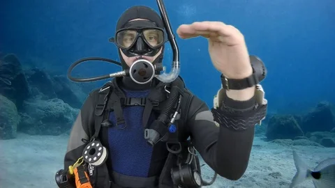 Divemaster shows signal -hover Stock Footage 128928530