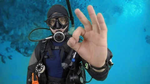 Divemaster shows signal - OK Stock Footage 122657514