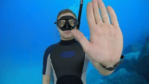 Divemaster shows signal – STOP Stock Footage 124320868