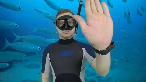 Divemaster shows signal – STOP Stock Footage 124320889