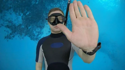 Divemaster shows signal – STOP Stock Footage 124320891