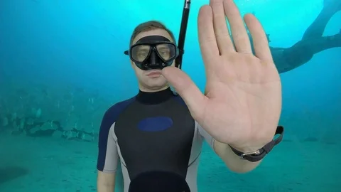 Divemaster shows signal – STOP Stock Footage 124320892