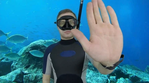Divemaster shows signal – STOP Stock Footage 124320894