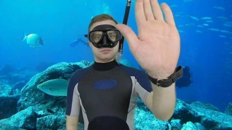 Divemaster shows signal – STOP Stock Footage 124320911
