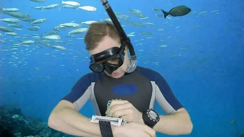 DIVEMASTER IS WRITTING ON THE PLATE SIGNA- UP Stock Footage 127387594
