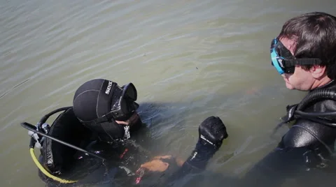 Diver (beginner) with diving instructor in the water Stock Footage 48384056