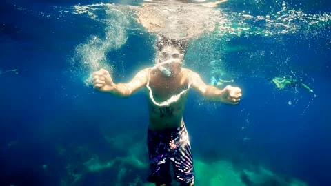 Diver Blow Bubble Rings while freediving in Spain Stock Footage 130912060