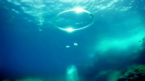 Diver Blow Bubble Rings while freediving in Spain Stock Footage 130912064