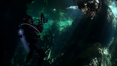 Diver with camera in cave maze of underw... | Stock Video | Pond5