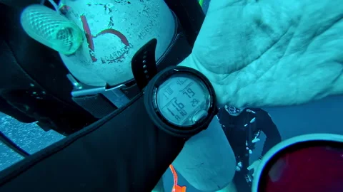 Diver Checking Dive Computer while Scuba Diving Underwater in Bali Stock Footage 330975153