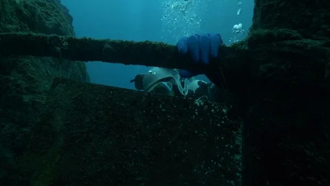 Diver close up that cleans plate at the bottom of the lake, San Domenico Lake Stock Footage 104584702