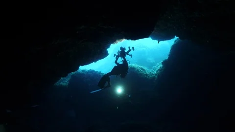Diver come out of the crack under the rocks, Ustica, Mediterranean sea Stock Footage 126872266