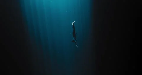 Diver descending into the darkness Stock Footage 270110532