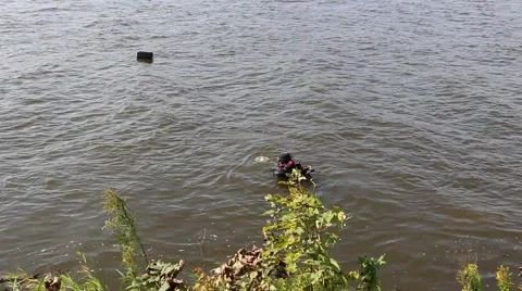 A diver diving with metal detecor in the river 스톡 동영상 41854199