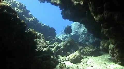 A diver entering a cave system Stock Footage 22571572